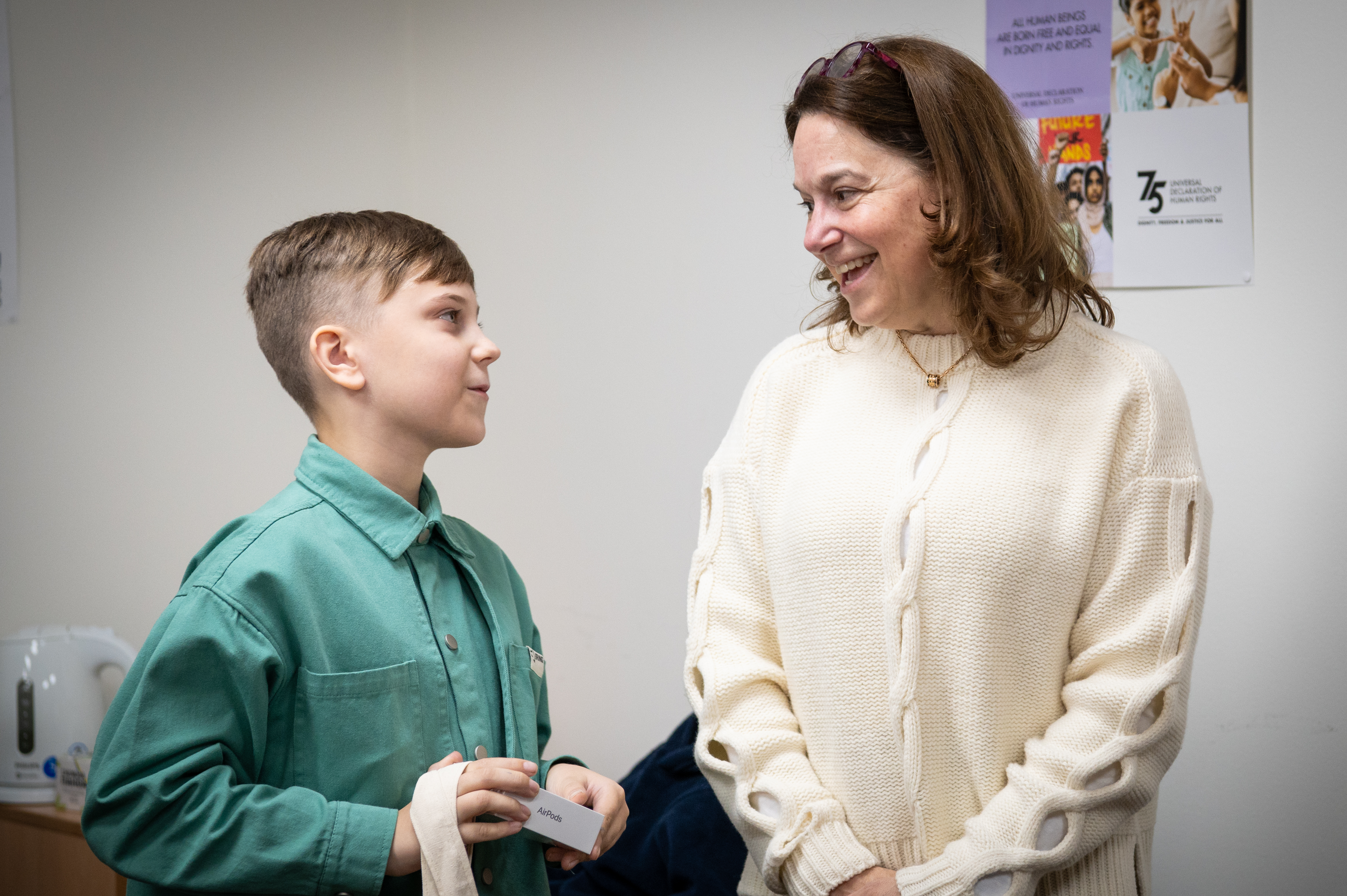 Andriy receives a prize from the Head of HRMMU Danielle Bell. Credit: OHCHR